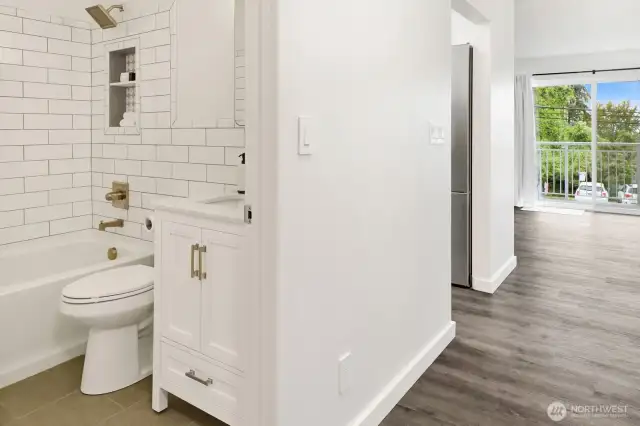 Bathroom with view of kitchen and living room
