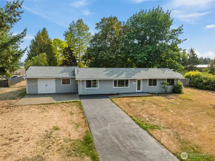 Enjoy easy, all-on-one-level living on just under an acre with a bonus two car garage and shop!