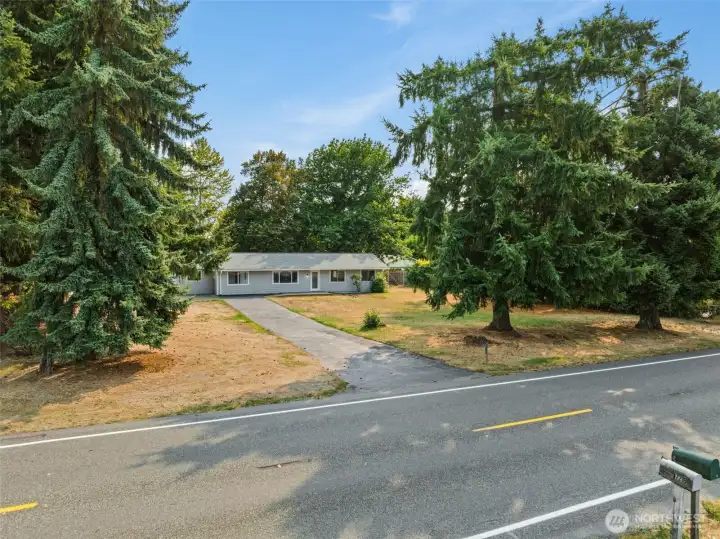 Enjoy easy, all-on-one-level living on just under an acreThis home sits back from the street with a long
