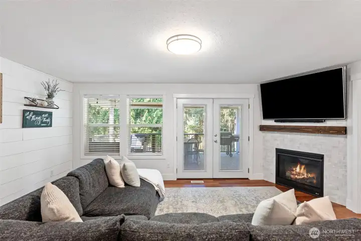 Main level living room opens to fully covered back deck.