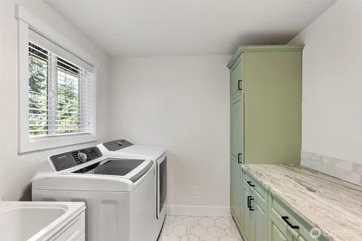 Utility room off of living room has doors both to the back deck and the garage.