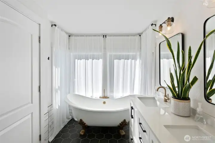 Primary bedroom ensuite with clawfoot bathtub.