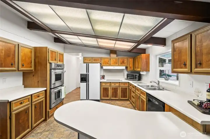 Open kitchen with eating bar.