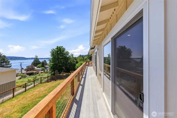 Expansive upper floor balcony with access off the primary bedroom and other west facing bedroom with water and Mt. Rainier views! Expansive upper floor balcony with access off the primary bedroom and other west facing bedroom with water and Mt. Rainier views!