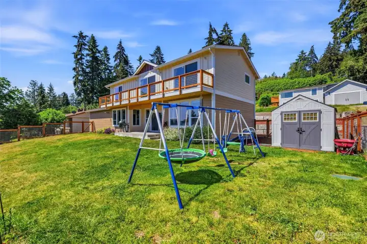 Outdoor shed plus space for gardening, entertaining, and a play area with rubber mulch. Outdoor shed plus space for gardening, entertaining, and a play area with rubber mulch.
