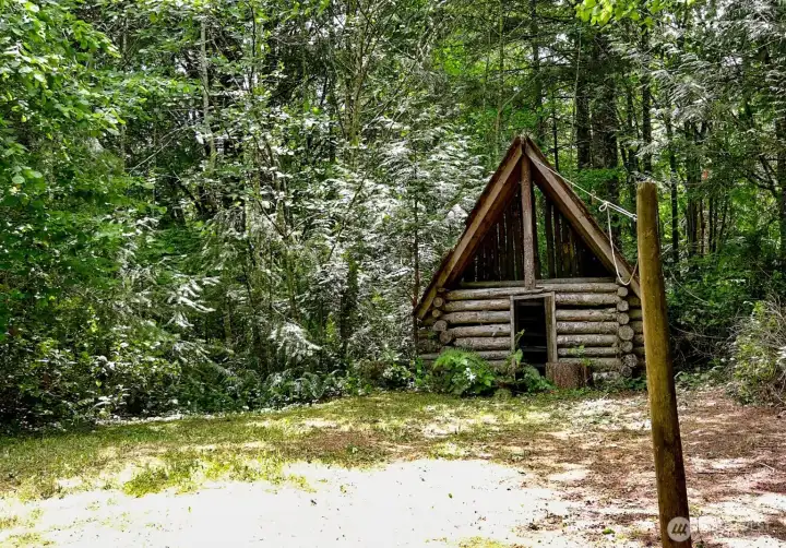 Log playhouse across the way