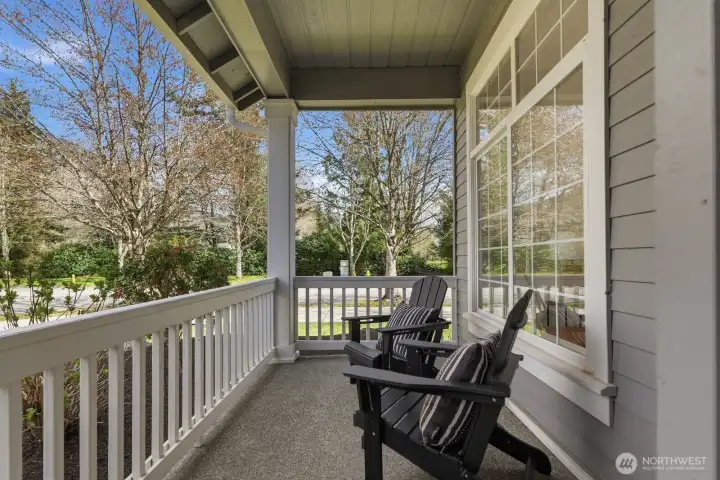 Charming covered front porch creating warm and welcoming curb appeal.