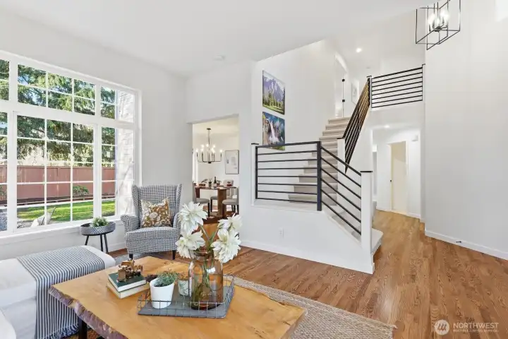 Custom remodeled staircase showcasing new powder-coated metal railings that enhance the home’s open, modern feel.