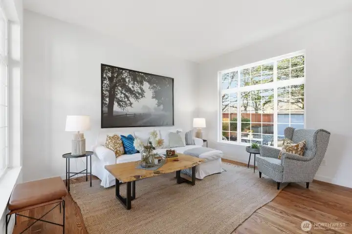 Extensively refreshed interior featuring refinished hardwood floors, new millwork, updated hardware and lighting, fresh paint, and new carpet throughout.