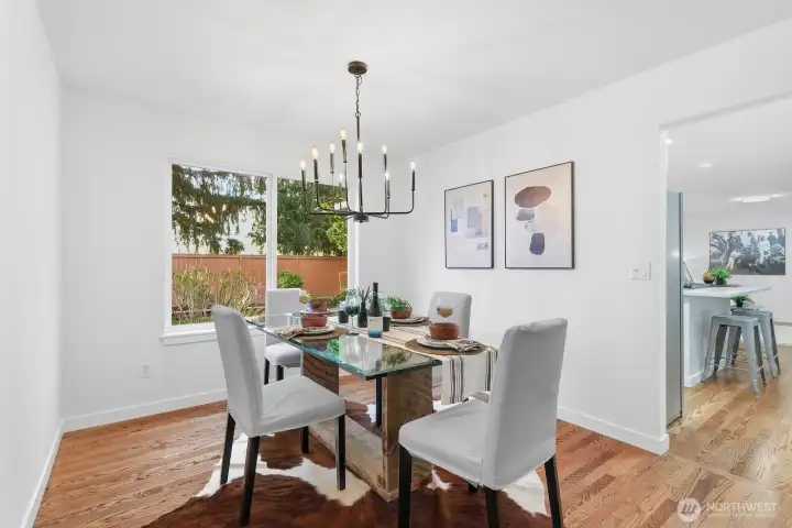 Dining room space seamlessly connecting the living room and kitchen with gorgeous backyard views.