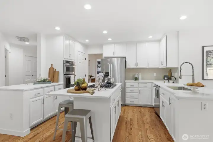 Beautifully remodeled kitchen showcasing gorgeous Elysio quartz countertops, mosaic tile backsplash, undermount sink, and spacious walk-in pantry.