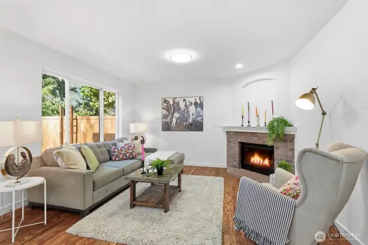 Family room featuring a gas fireplace with charming brick surround.