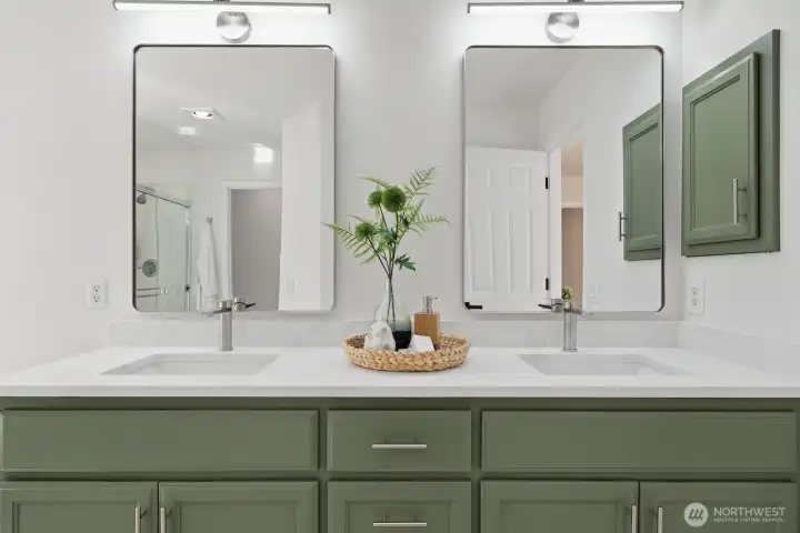 Stunning double-sink vanity with new undermount sinks, stylish mirrors, modern lighting, and updated faucets/hardware.