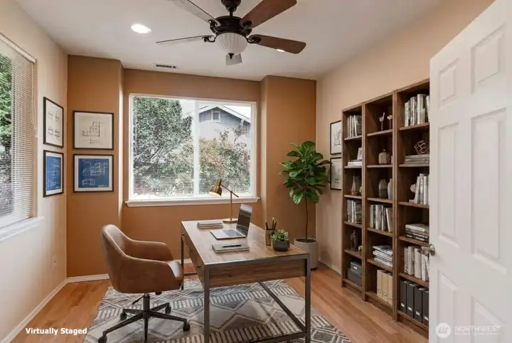 French doors lead to the den.  Separated from the main living room, this space works great as an office or sewing/craft room. Notice the whisper quiet ceiling fan.
