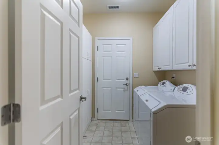 Utility room with added storage.  Door leads to the garage.