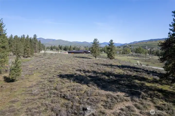 Expansive level ground and distant mountain views frame a rare opportunity to own one of Winthrop's last large available parcels.