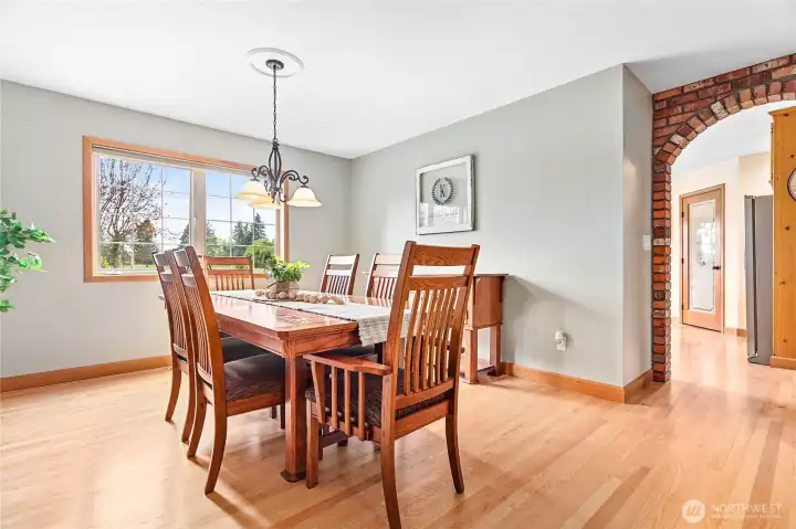 Spacious dining room just through arch from kitchen w/built-in bump out for buffet and continued refinished oak flooring throughout