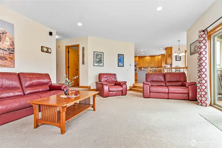 Family room location well-planned for relaxing, entertaining, and privacy. Half bath through door to left and hall leading to garage and office