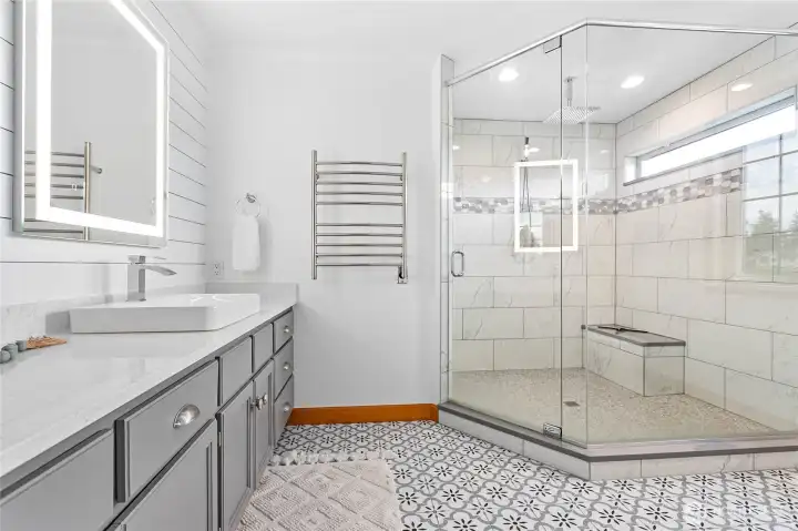 Recently remodeled ensuite bathroom with gigantic walk-in shower, beautiful tile flooring and lovely ship-lap wall
