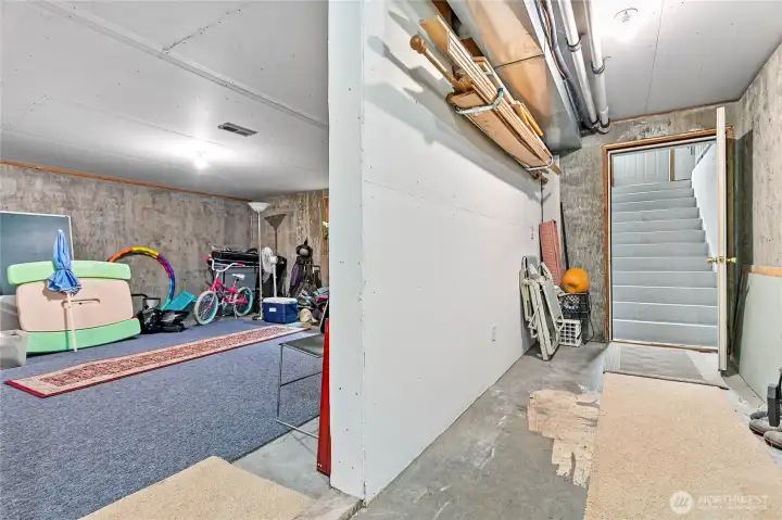 Last but not least - just off storage room is utility area with stairwell leading to garage & man door beyond. Lends well for multi-gen living with basement access direct