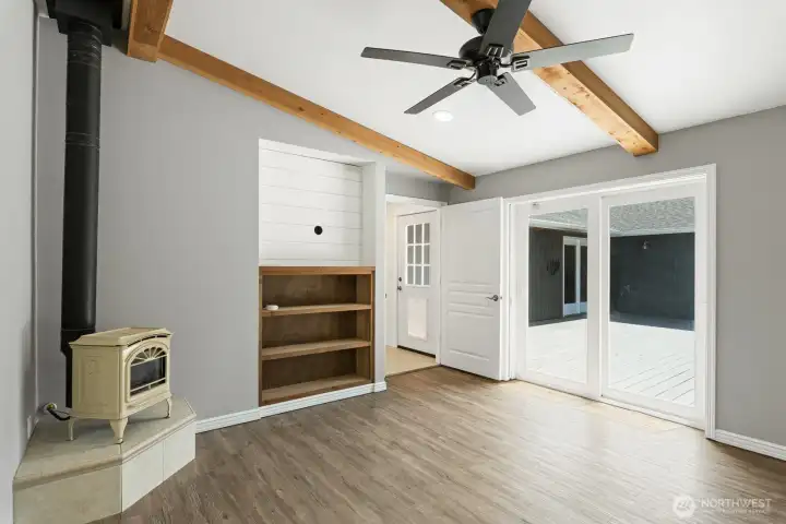 Another view in Primary with gas fireplace and doors leading to back deck