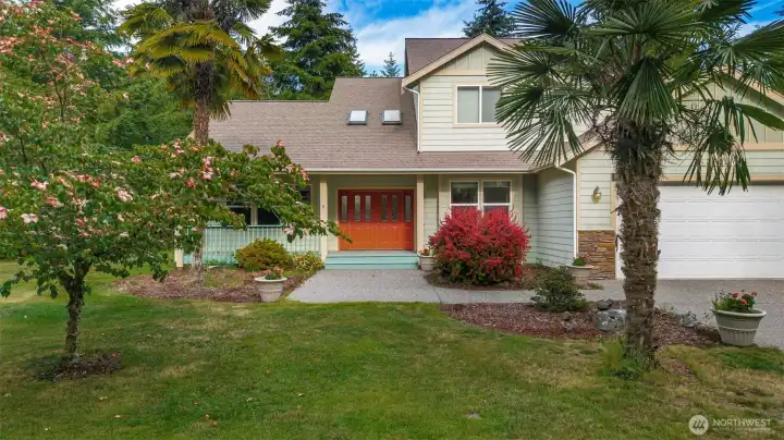 Craftsman detailing and a welcoming red front door, and yes — those are palm trees. The attached three-car garage and lush landscaping complete this home. Craftsman detailing and a welcoming red front door, and yes — those are palm trees. The attached three-car garage and lush landscaping complete this home.