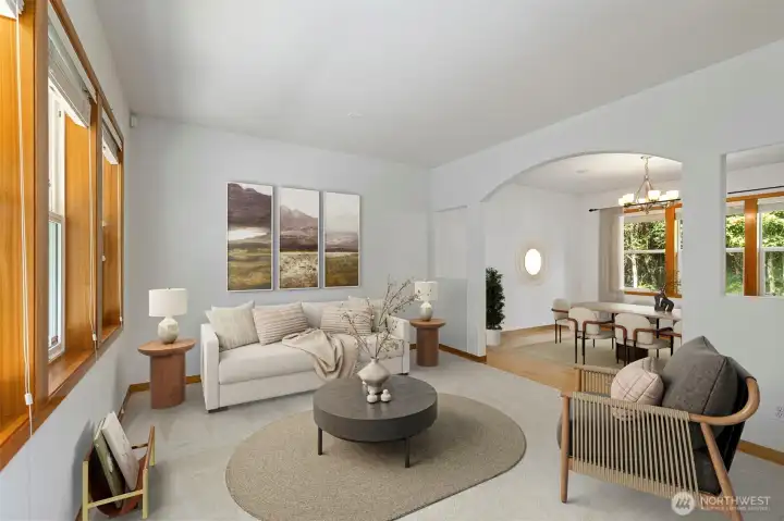 The living room offers comfortable proportions and connects naturally to the dining area through an arched passage. Virtually staged. The living room offers comfortable proportions and connects naturally to the dining area through an arched passage. Virtually staged.