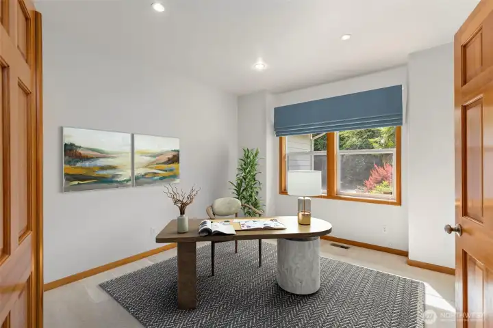A flexible main floor room with recessed lighting and a wooded view — currently shown as a home office. Virtually staged. A flexible main floor room with recessed lighting and a wooded view — currently shown as a home office. Virtually staged.