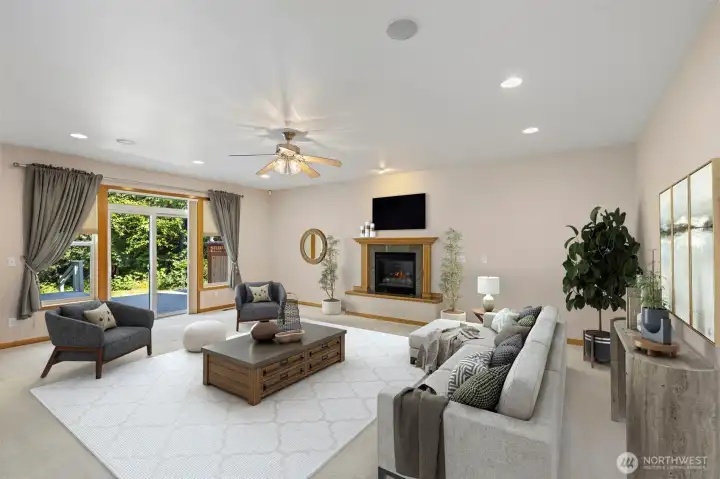 The great room is where the home opens up — built-in ceiling speakers, a fireplace, a ceiling fan, and sliding doors to the deck make it an easy place to settle in. Virtually staged. The great room is where the home opens up — built-in ceiling speakers, a fireplace, a ceiling fan, and sliding doors to the deck make it an easy place to settle in. Virtually staged.
