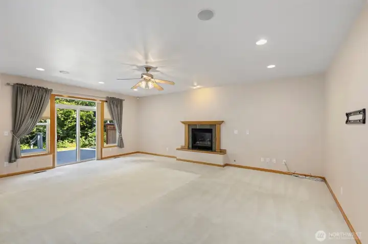 Generous square footage, a fireplace, ceiling fan, and slider to the deck — the great room has good bones and a lot of flexibility. Generous square footage, a fireplace, ceiling fan, and slider to the deck — the great room has good bones and a lot of flexibility.