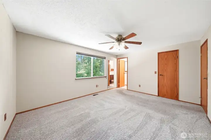 Primary bedroom looking straight ahead to 3/4 bath. Door to walk-in closet is to the right.