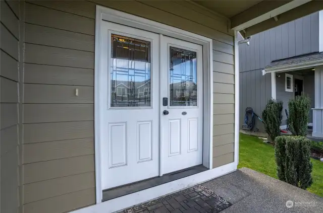 Double door entrance with a covered patio.