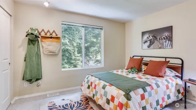 Generously sized guest bedroom upstairs bathed in natural light.