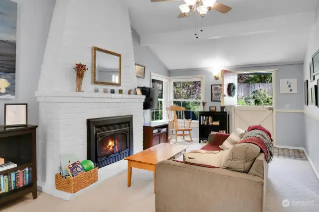 A view of the living room from the dining room table .Note the cheerful Dutch door...letting in sunshine and fresh air!