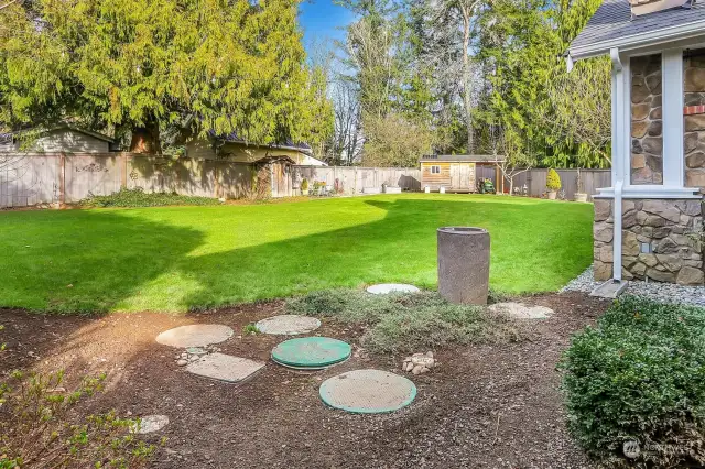 Wide angle of backyard toward the shed.