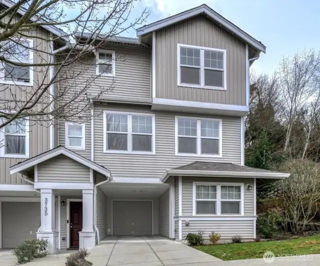 Set back from the street, surrounded by mature trees, offering a warm welcome home, complete with an oversized garage and parking in front of garage.