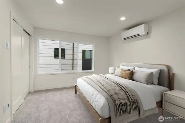 This image is virtually staged. The primary suite is ready for your king-size bed and binge-watching setup. Bonus: ductless mini-split keeps it comfy all year.