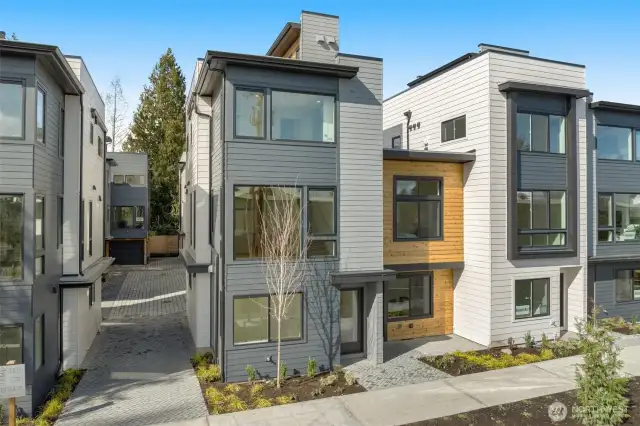 This is the kind of curb appeal that makes you slow down mid-walk. Clean lines, designer materials, and just steps from your EV-ready parking spot.