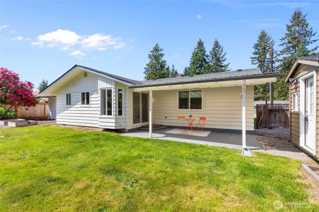 View of back of home with garden beds