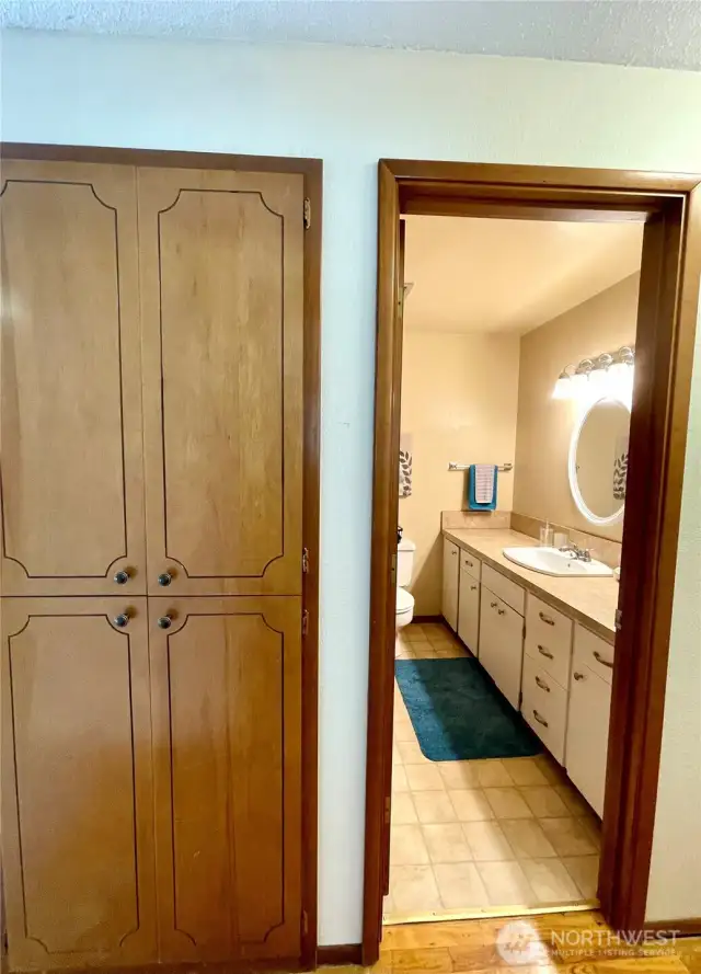 Linen closet and full bathroom.