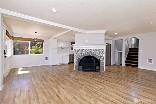 Neat great room! The fireplace is non-functional, but a funky-cool focal point for the living area. Fill it with plants or candles or whatever floats your boat!