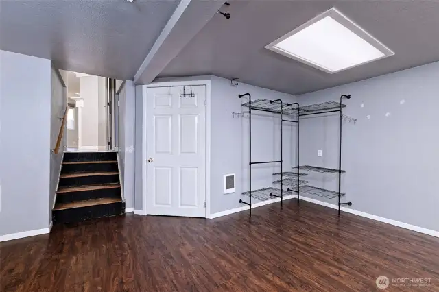 This is the lowest floor - a short flight of steps from the living room. This qualifies as a bedroom, but it could be a great home office - there are French doors leading out the beautiful deck. Behind the white door is the utility room with the washer/dryer.