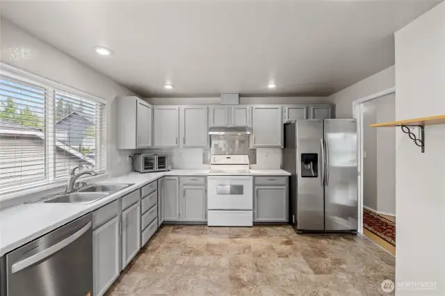 Laminate countertops and brand new stainless steel dishwasher.