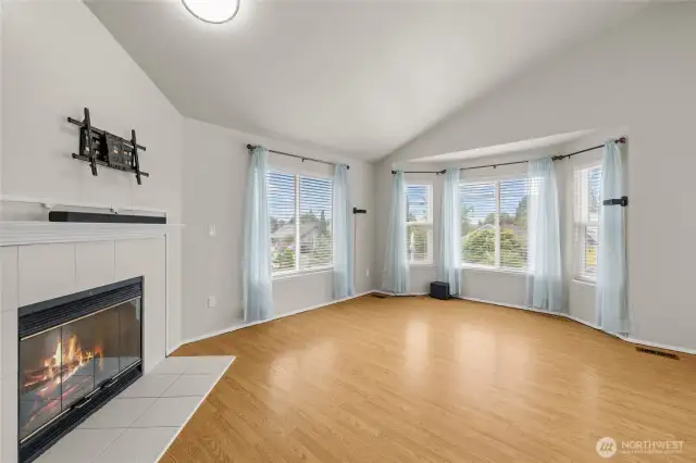 Cozy fireplace anchors the spacious living area.