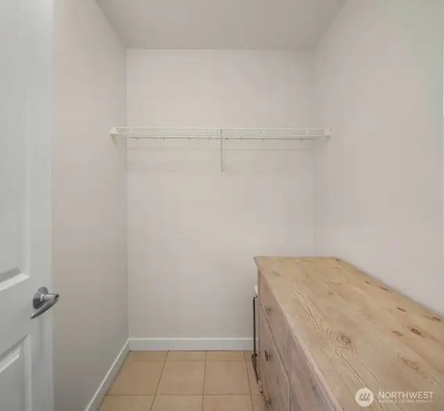Across the hall from the bathroom you'll find the walk-in closet - currently inside is a large dresser yet still tons of space.