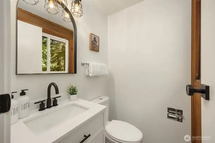 Freshly updated powder room off of the flex space