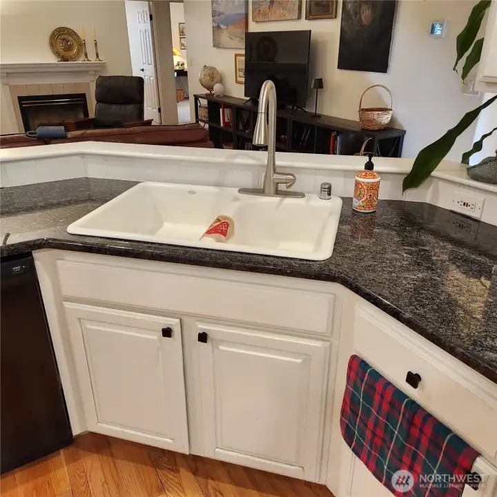 The sink is a deep double enamel sink, big enough to hold large pans