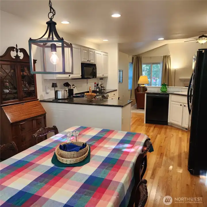 Right beyond the kitchen in the dining room (or kitchenette eating area) Large windows bring in natural light.