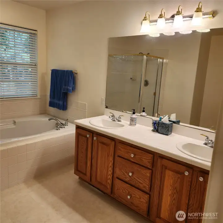 Dual sinks. And the toilet is in a little alcove behine the door.