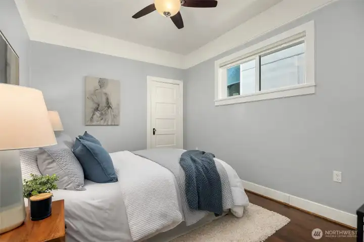 A main level bedroom with high ceilings.